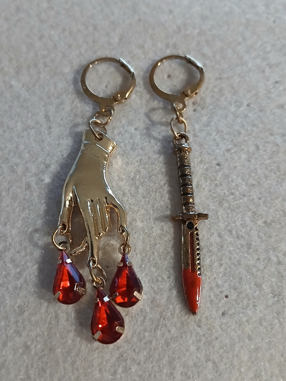 199- Gold Hand & Dagger Asymmetric Earrings with Red Crystal Drops